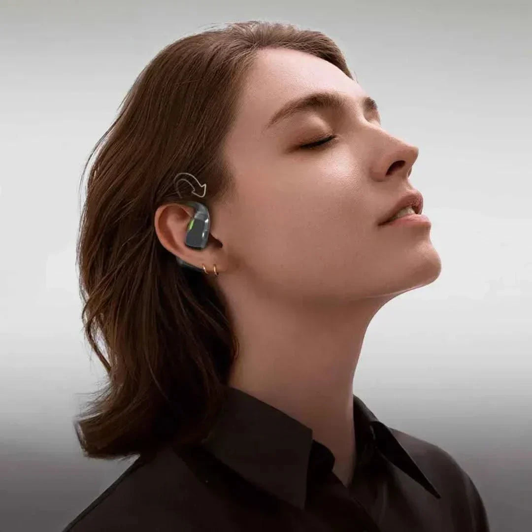 Bluetooth ear hook translator with Hi-Fi audio, worn by a person for real-time translation.